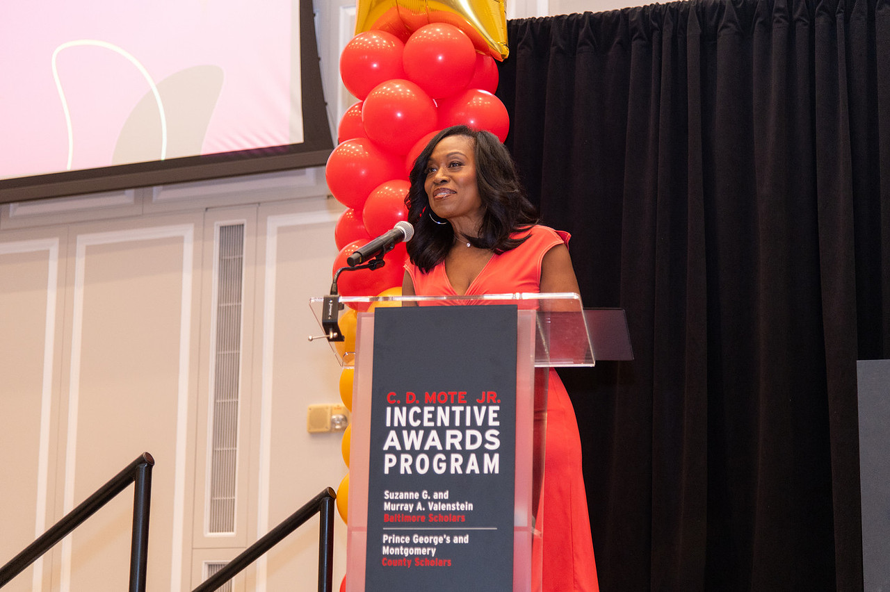 Jackie speaks at podium